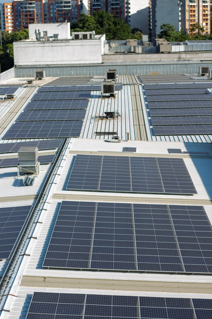 Services Aerial view of solar panels on an urban rooftop in Valle del Cauca, Colombia.