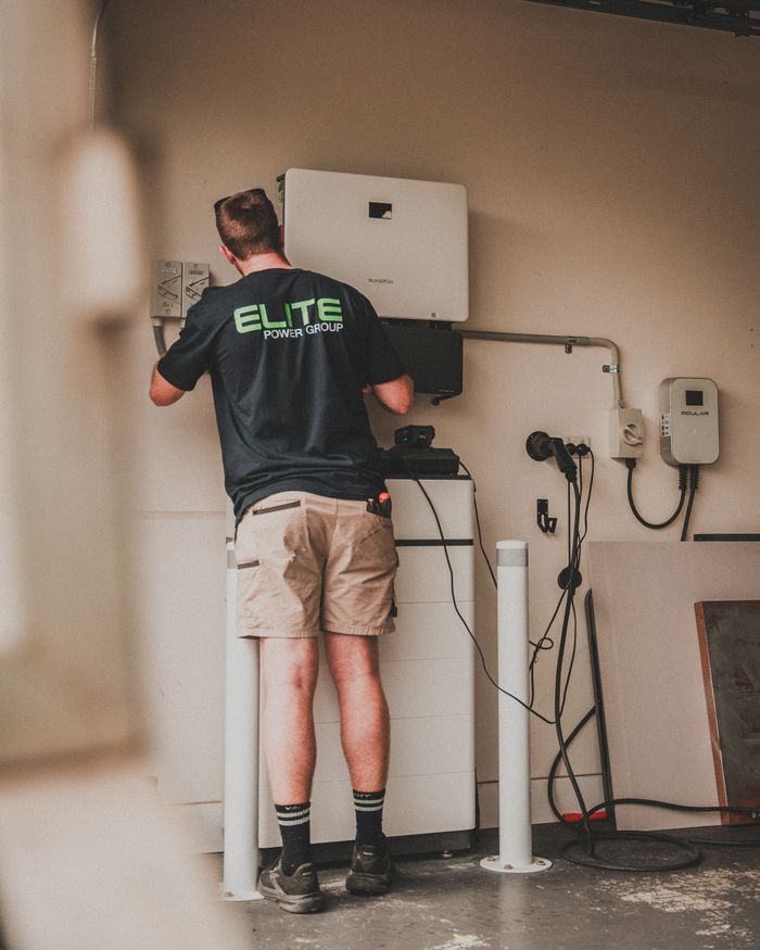 Mastering the First Impression: Your intriguing post title goes here Technician working on the installation of a residential solar battery system indoors.